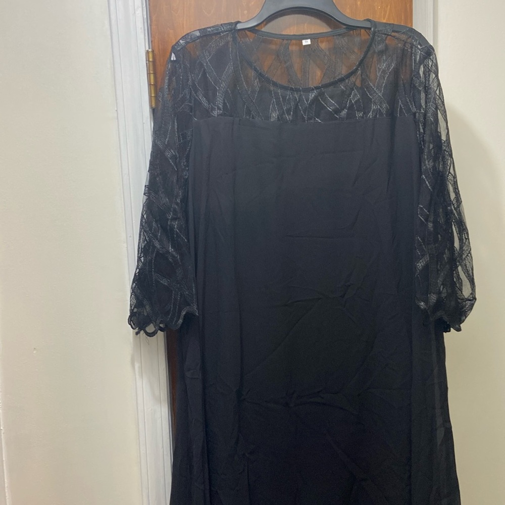 Black dress with sharkbite hem.